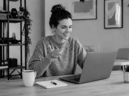 A woman talking on a video call at her laptop