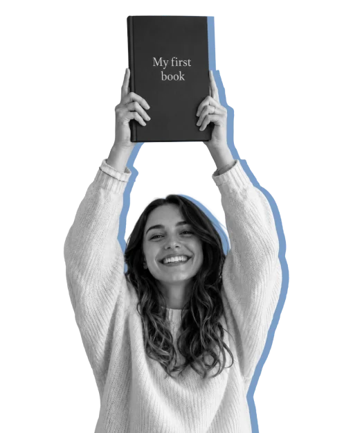 An author holding her first book above her head